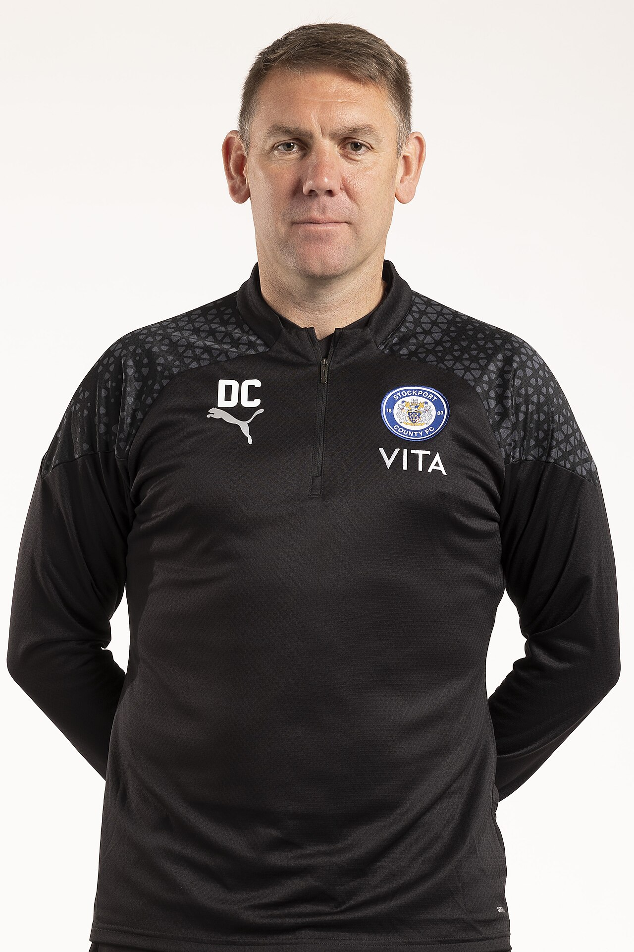 Dave Challinor wearing a black Stockport County training top.